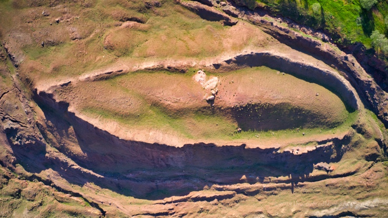 A aerial view of a hill

Description automatically generated