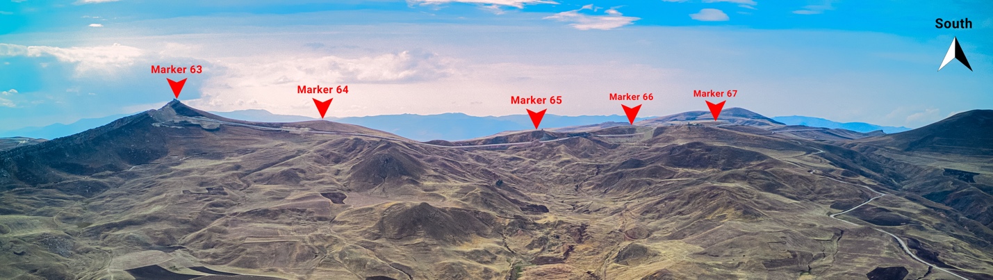 A group of mountains with red triangles

Description automatically generated